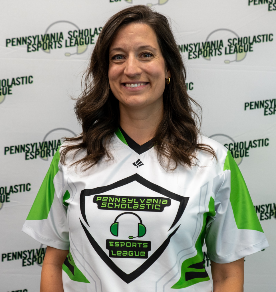 Person wearing a Pennsylvania Scholastic Esports League jersey, smiling, with a branded backdrop behind them.